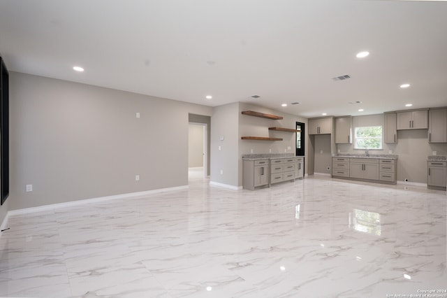 unfurnished living room with sink