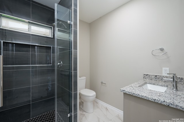 bathroom featuring walk in shower, vanity, and toilet