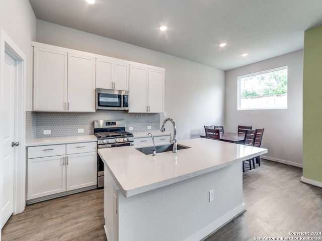 kitchen featuring white cabinets, sink, and stainless steel appliances