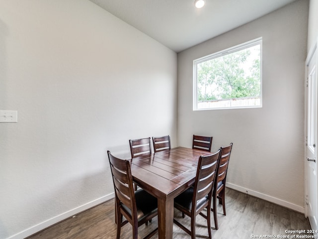 dining room featuring lofted ceiling and hardwood / wood-style flooring