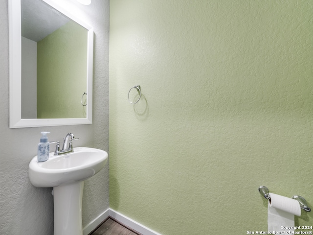 bathroom with sink and hardwood / wood-style floors