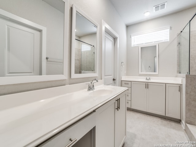 bathroom with vanity, a shower with door, and tile patterned flooring