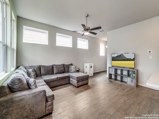 living room featuring hardwood / wood-style floors and ceiling fan