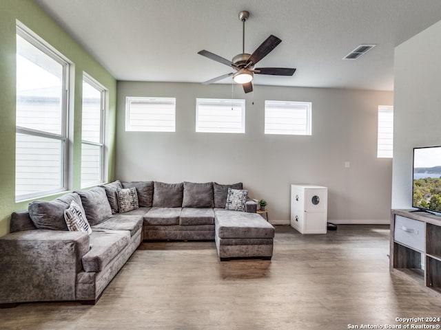 living room featuring hardwood / wood-style floors, ceiling fan, and plenty of natural light