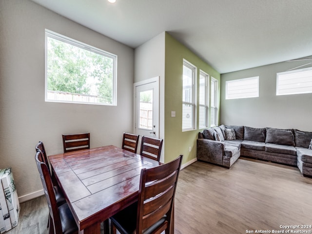 dining space with wood-type flooring