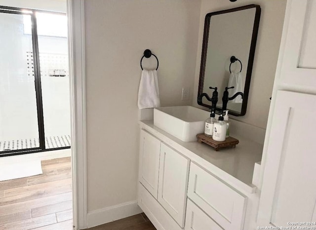 bathroom with vanity and hardwood / wood-style floors