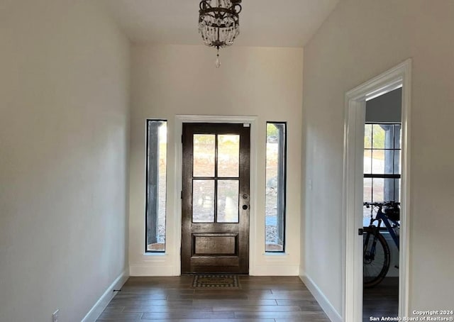 entryway featuring dark hardwood / wood-style floors and an inviting chandelier