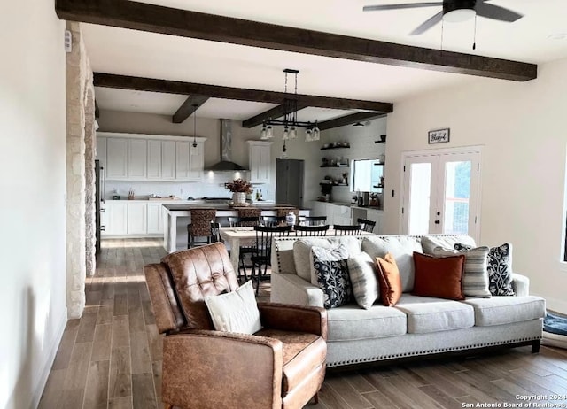 living room with beamed ceiling, ceiling fan with notable chandelier, french doors, and dark hardwood / wood-style flooring