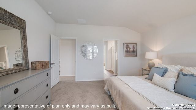 bedroom featuring light colored carpet and vaulted ceiling