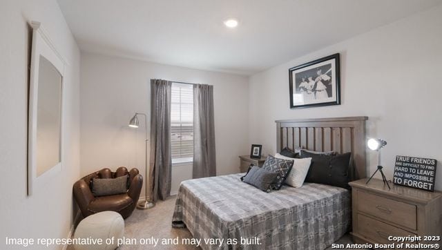 bedroom featuring light carpet