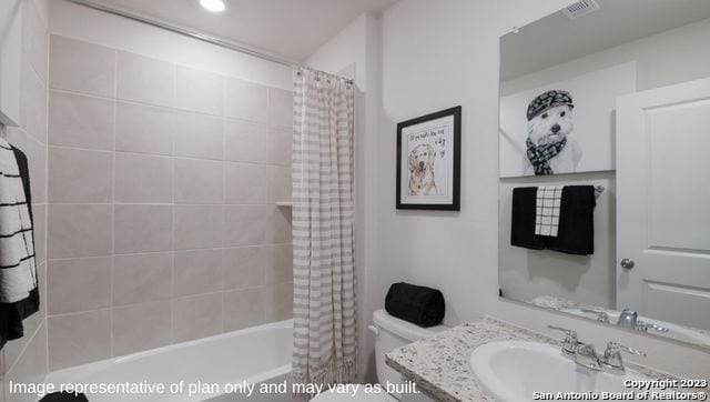 full bathroom featuring toilet, vanity, and shower / bath combo with shower curtain