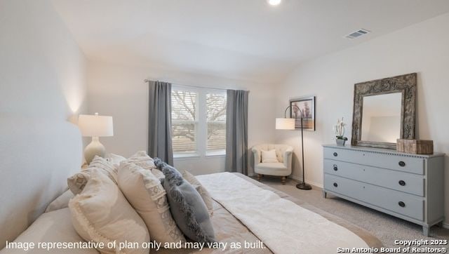 carpeted bedroom with vaulted ceiling