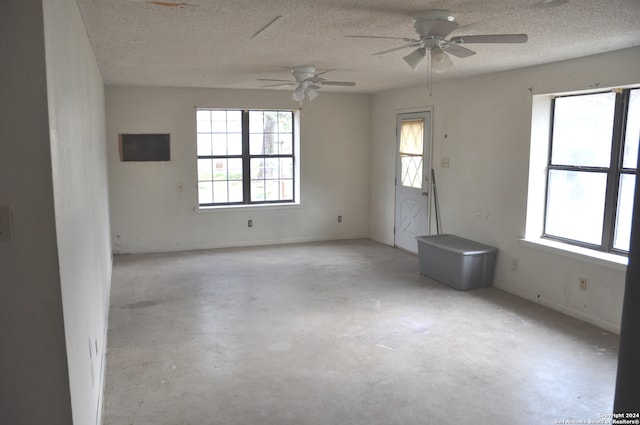 spare room featuring plenty of natural light and a textured ceiling