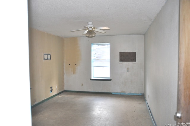 empty room with a textured ceiling and ceiling fan