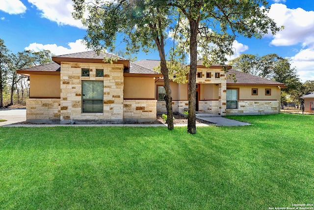 rear view of property featuring a lawn