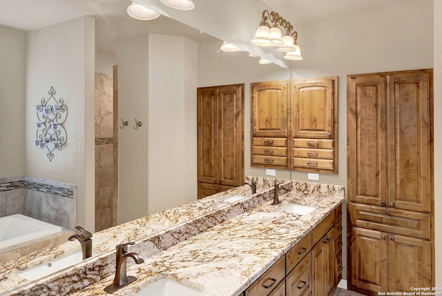 bathroom featuring vanity and tiled bath