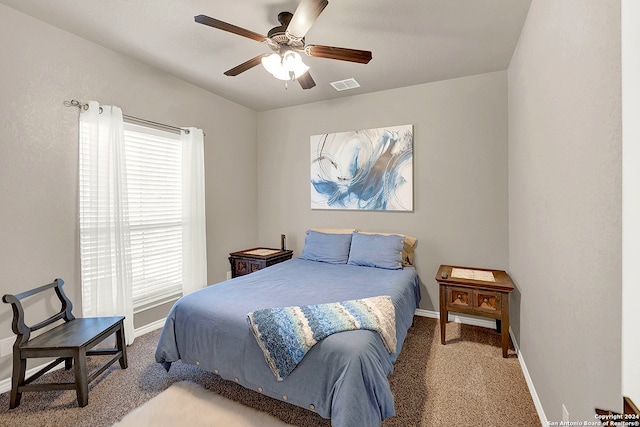 bedroom featuring ceiling fan and carpet