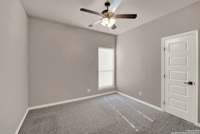 spare room featuring ceiling fan and carpet