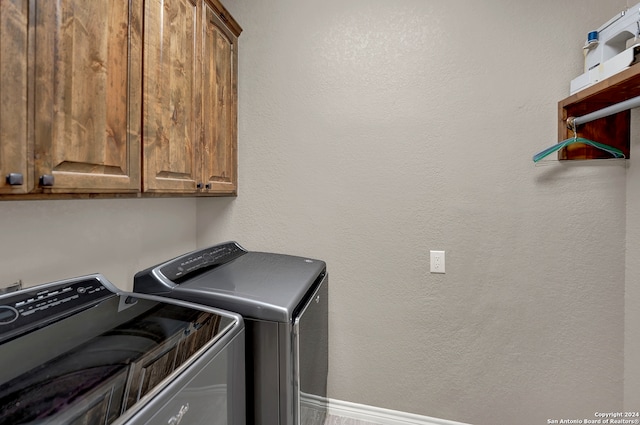 laundry area featuring cabinets and washer and dryer