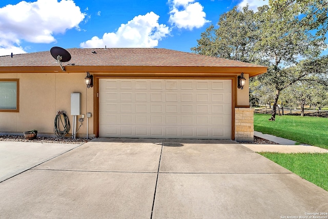 garage featuring a lawn