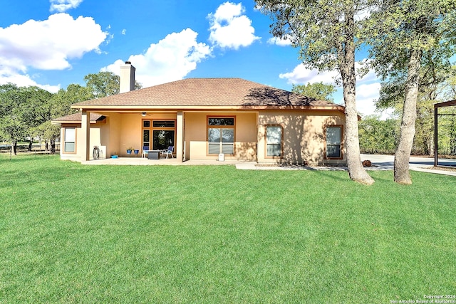 rear view of house with a patio area, a lawn, and ceiling fan