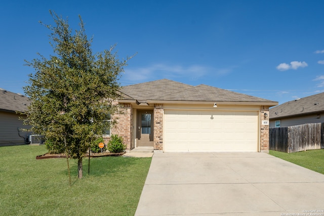 view of front of home with central AC unit, a garage, and a front yard