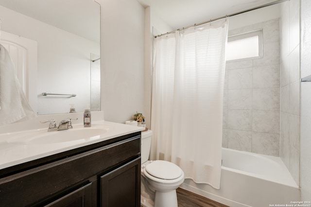 full bathroom featuring hardwood / wood-style floors, vanity, shower / bathtub combination with curtain, and toilet