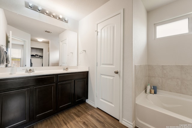 bathroom featuring vanity, a tub, and hardwood / wood-style flooring