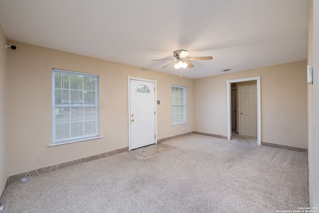 interior space with ceiling fan and light carpet