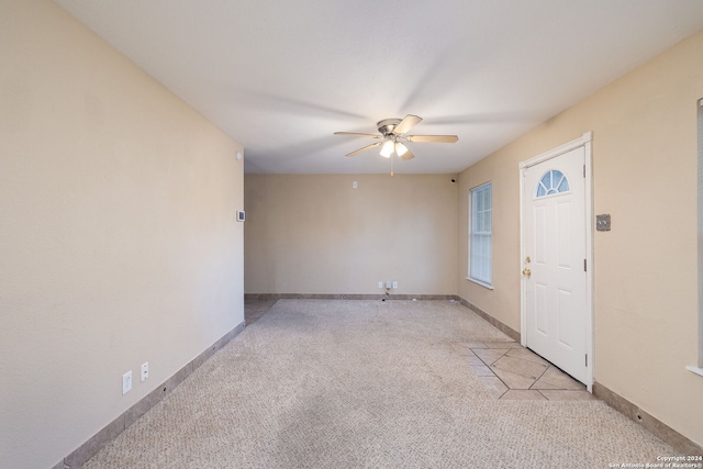 carpeted foyer featuring ceiling fan