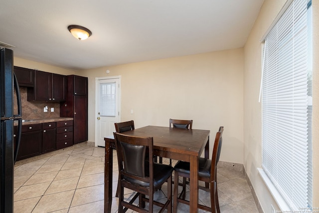 dining space featuring light tile patterned flooring