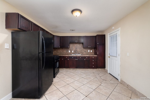 kitchen featuring black appliances, sink, tasteful backsplash, light tile patterned floors, and dark brown cabinets