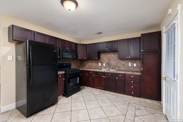 kitchen with sink, black appliances, light tile patterned floors, backsplash, and dark brown cabinets