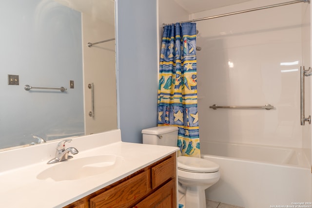 bathroom with toilet, vanity, and tile patterned floors