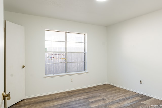 spare room with hardwood / wood-style flooring