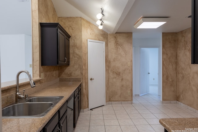 kitchen with dark brown cabinetry, light tile patterned floors, and sink