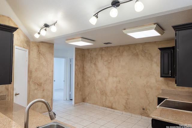 kitchen with sink and light tile patterned flooring