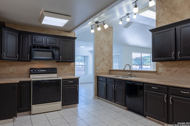 kitchen featuring black appliances, sink, light tile patterned floors, and rail lighting