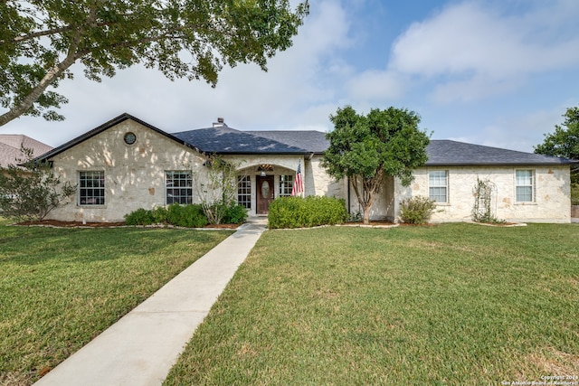 ranch-style house featuring a front lawn