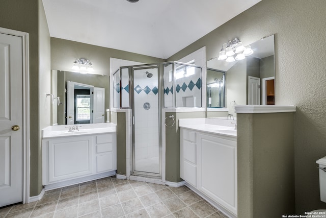 bathroom with a shower with shower door and vanity