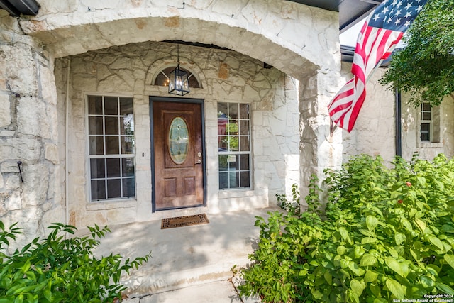 view of exterior entry with covered porch