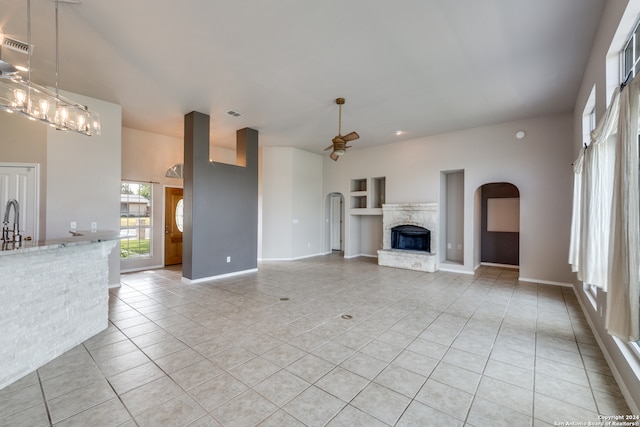 unfurnished living room with light tile patterned floors and ceiling fan