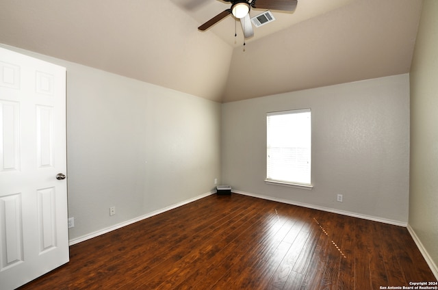 empty room with high vaulted ceiling, dark hardwood / wood-style floors, and ceiling fan