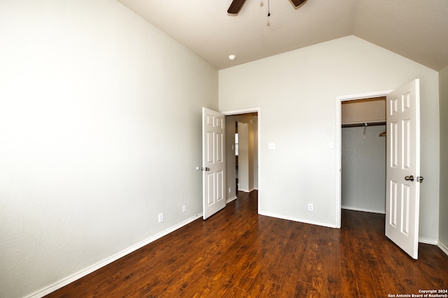 unfurnished bedroom with lofted ceiling, ceiling fan, a closet, and dark hardwood / wood-style flooring