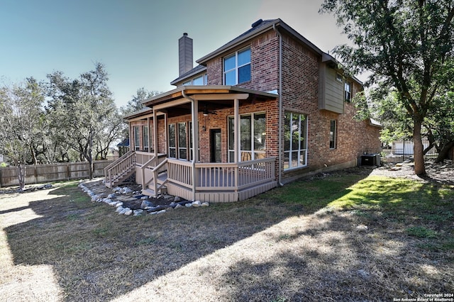 rear view of property featuring a deck