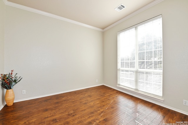 spare room with dark wood-type flooring and ornamental molding