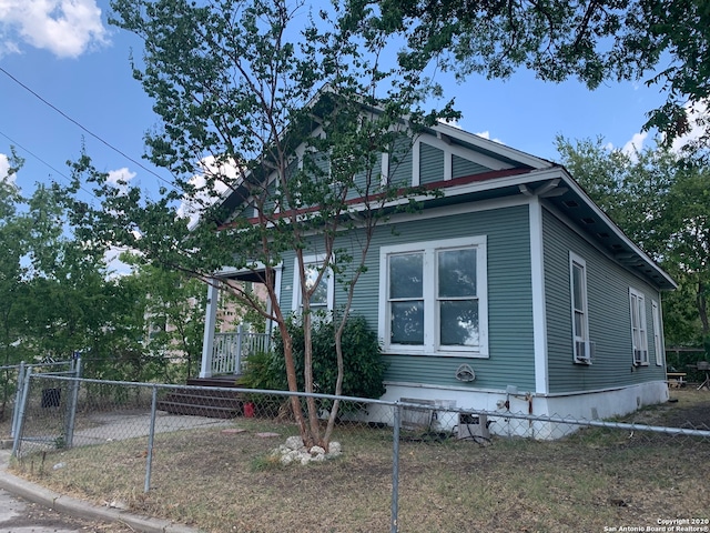 view of side of property featuring covered porch