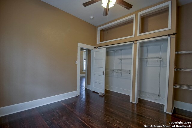 unfurnished bedroom featuring ceiling fan, a closet, and dark hardwood / wood-style flooring