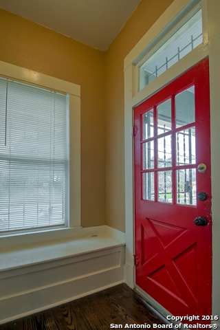 doorway with dark wood-type flooring