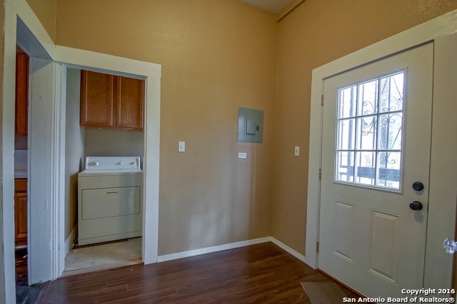 doorway featuring electric panel, washer / dryer, and dark hardwood / wood-style floors